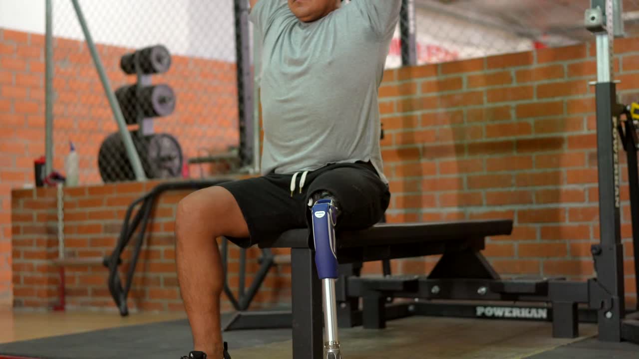 Man working out with dumbbells at the gym