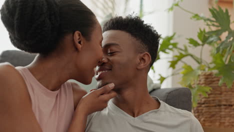 happy black couple eating in home together