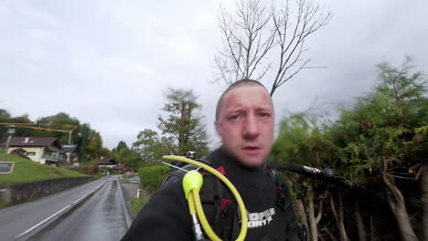 young caucasian man, short hair walk streets, film himself neoprene sports suit