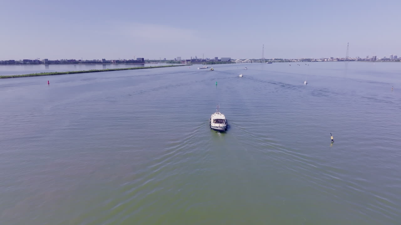 A tranquil moment captured from above, featuring a Dutch Luxemotor vessel on open water