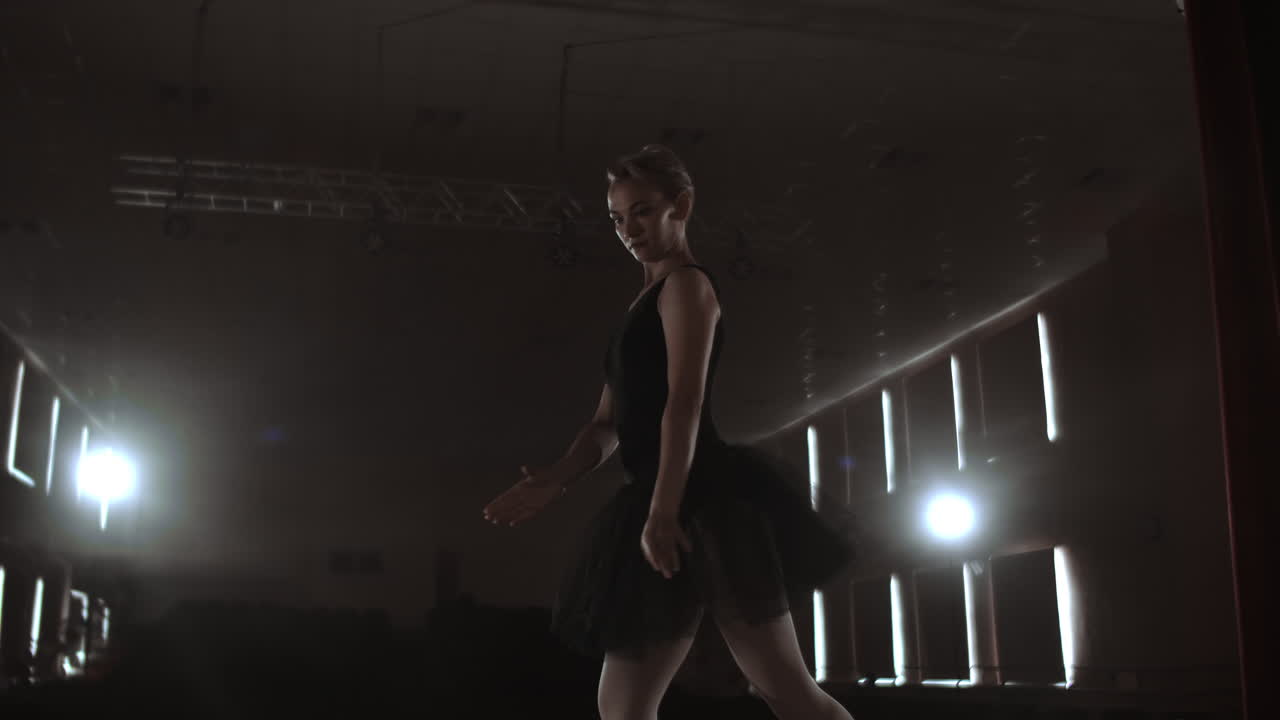 Arts and entertainment in theatre with female classic dancer in tutu standing behind the scenes and looking at stalls