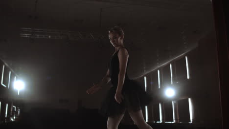 Arts-and-entertainment-in-theatre-with-female-classic-dancer-in-tutu-standing-behind-the-scenes-and-looking-at-stalls