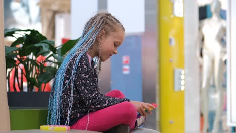 cute little girl playing with flapping fidget toy