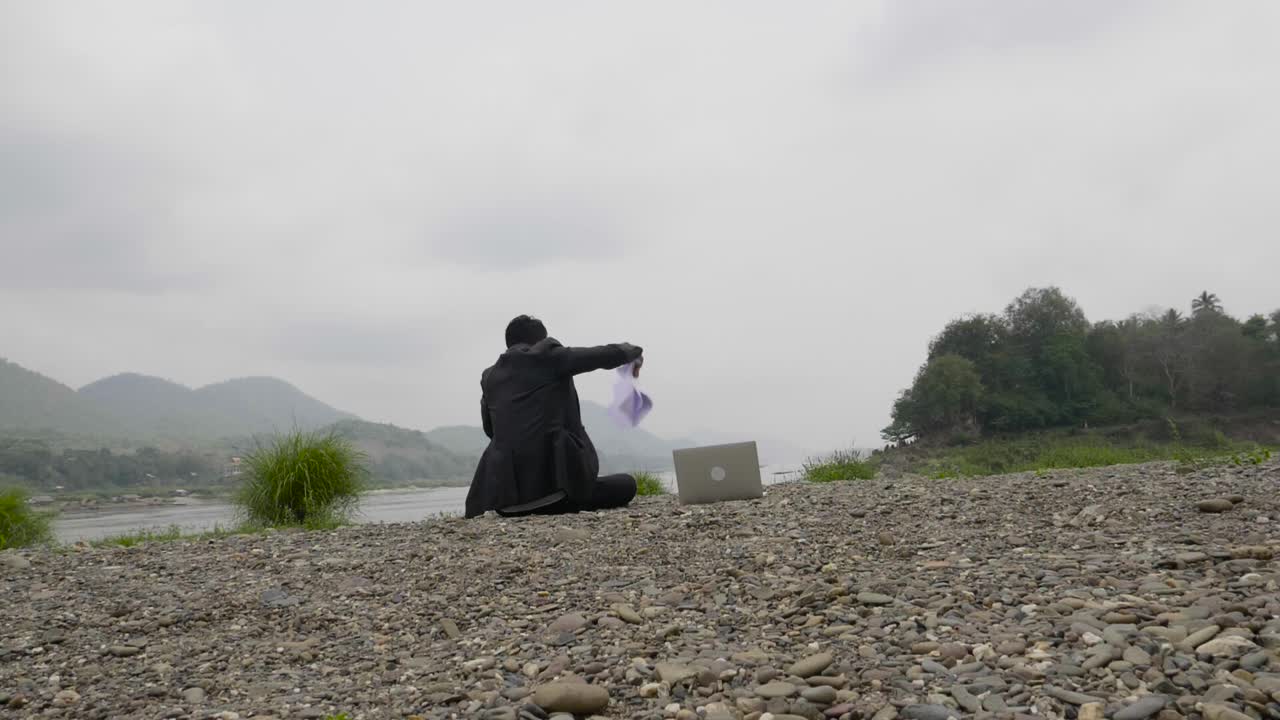 Businessman Relaxing by the River