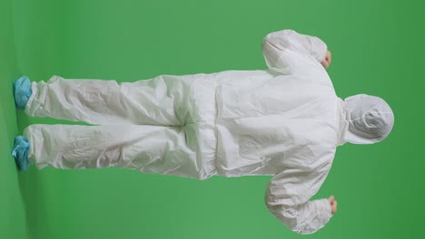 full body back view of asian male scientist celebrating the succeed while standing on green screen background