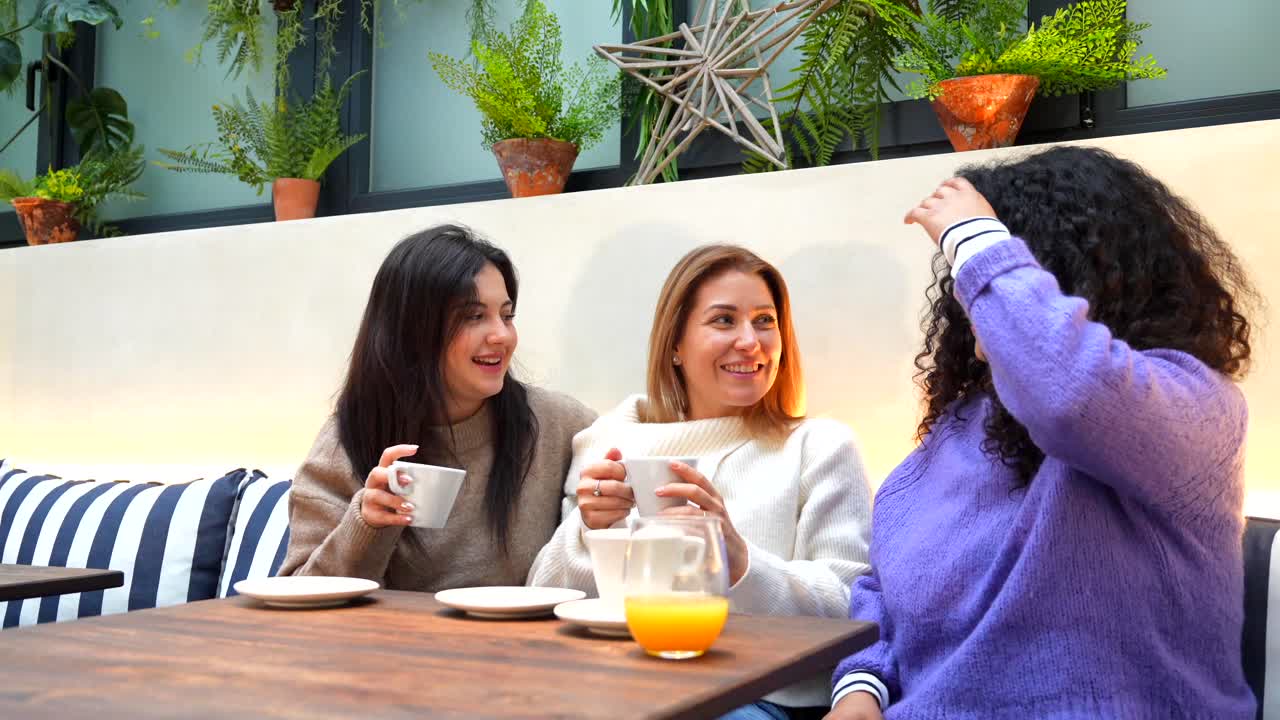Three friends enjoying coffee at a cafe