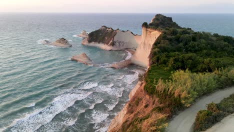 flying over the edge of cape drastis with waves crushing, corfu, greece