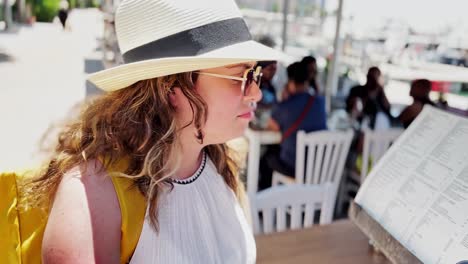 woman looking at menu in a seaside restaurant