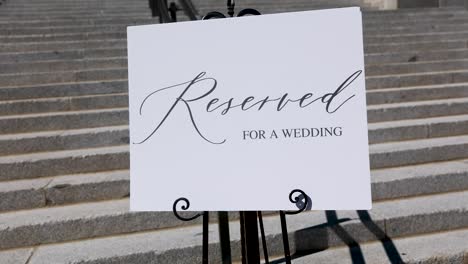 reserved sigh on white poster near wedding reception building with stairs