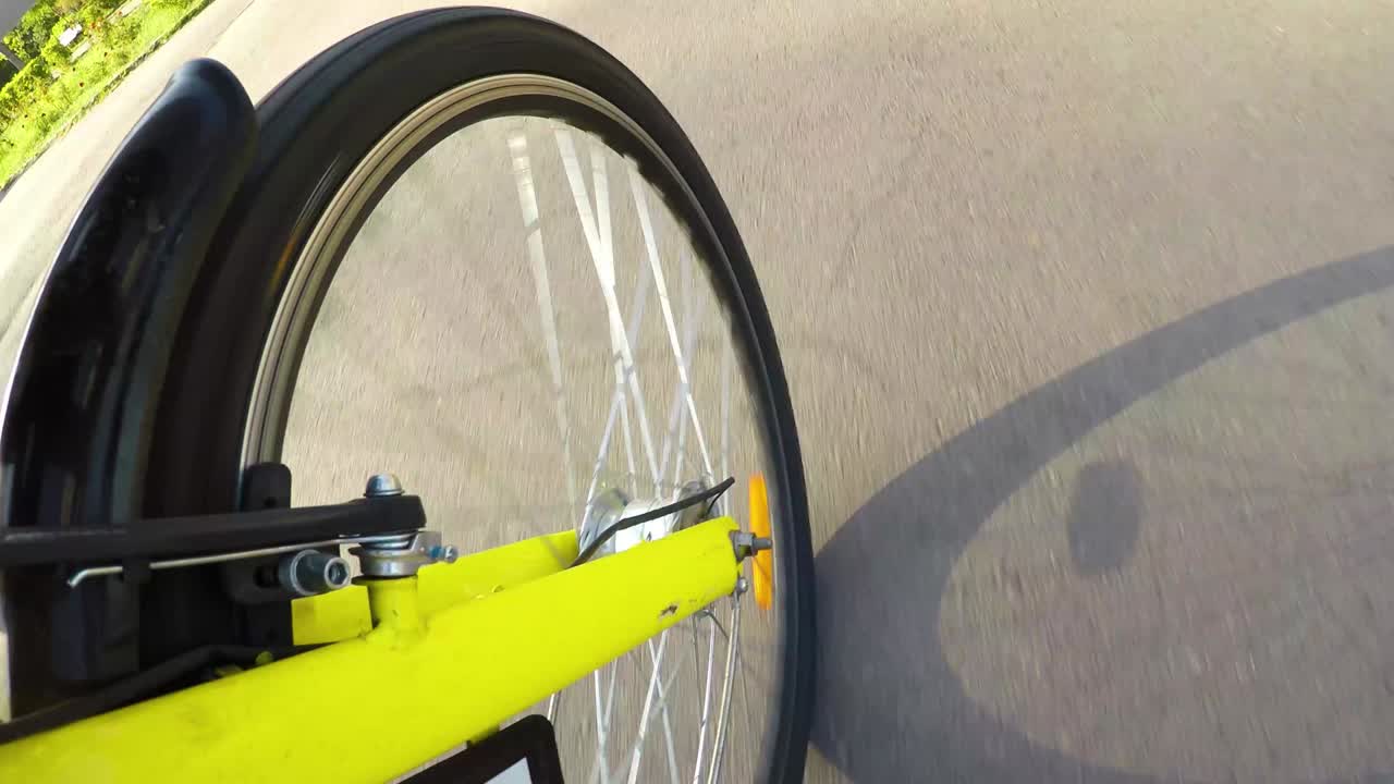Courier service on bicycle. Delivery service on the bike. Yellow bike, front wheel view.