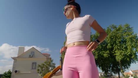 stylish woman outdoors in pink activewear