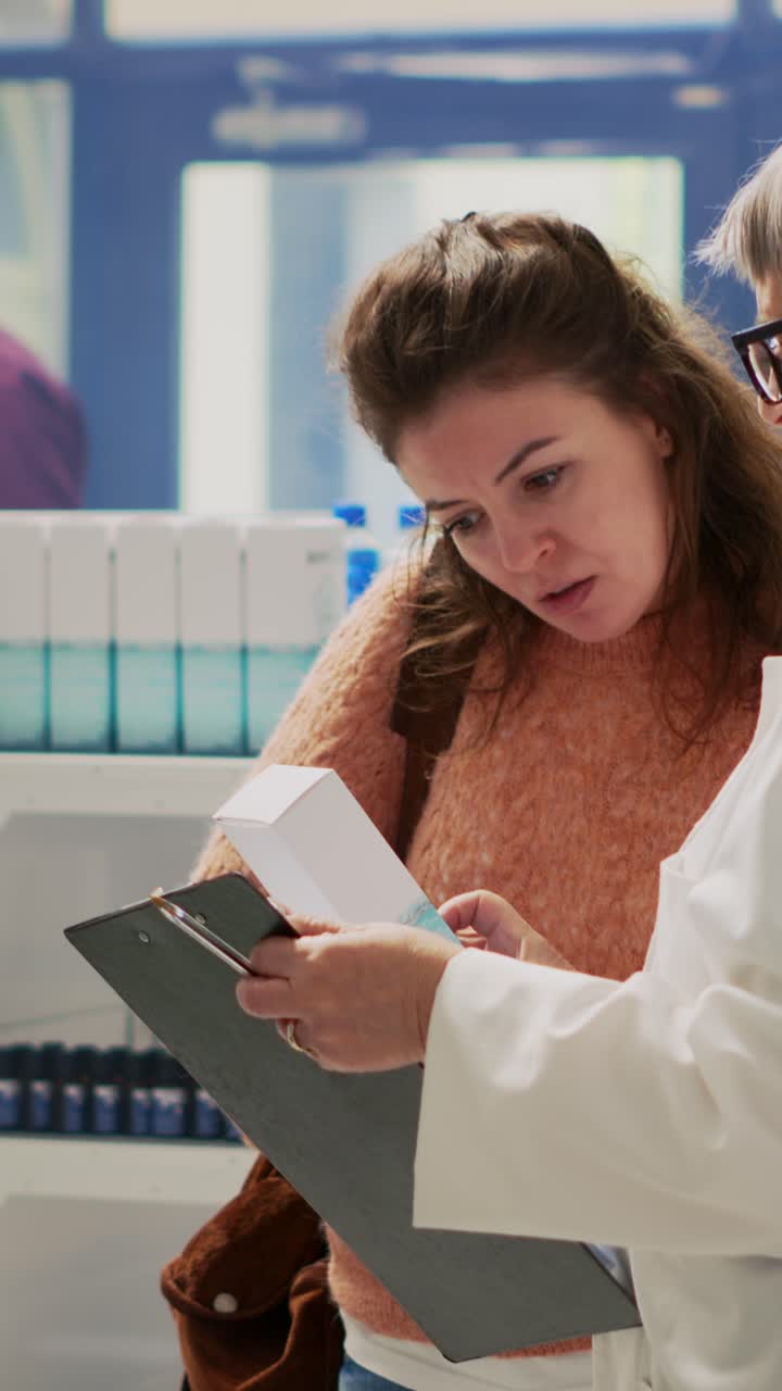 Vertical video: Female customer with stomachache asking pharmacist about gastritis pills