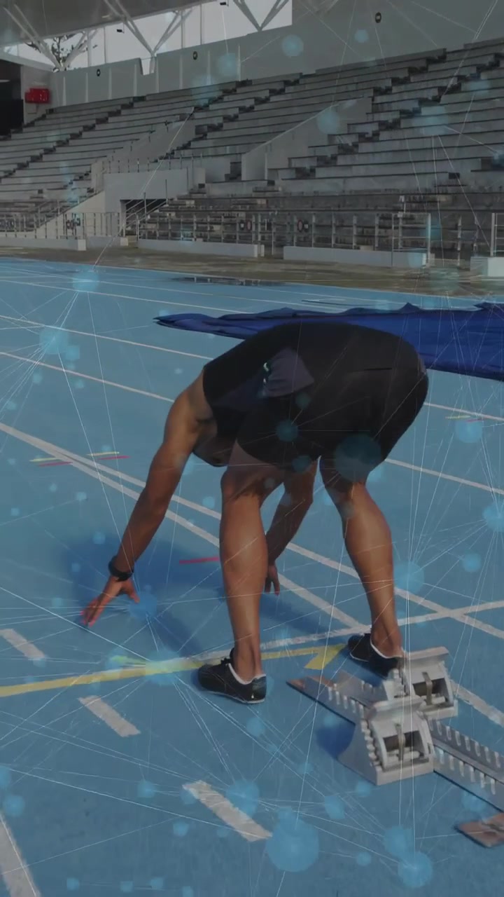 Vertical video: Sprinter approaching starting line, adjusting blocks and crouching for track start