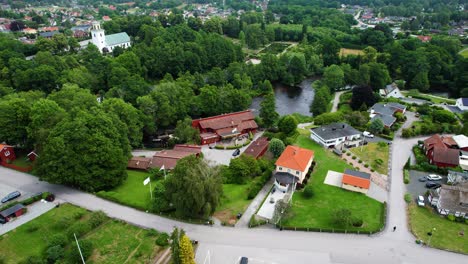 laxens hus by the morrum river in tranquil morrum town, blekinge, showcasing the swedish countryside, houses and greenery, aerial