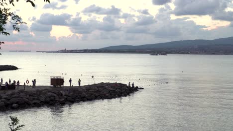 sunset at the coastal pier with people