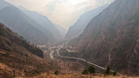 View-over-the-a-himalayan-mountain-valley,-clouds-and-smoke-over-the-nepalese-town-Syapru-Besi