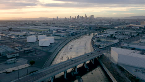 aerial view of los angeles skyline and la river at sunset