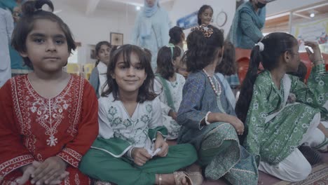 a group of children dressed in traditional attire, joyfully celebrating pakistan's independence day. their colorful outfits and cheerful expressions capture the festive spirit of the occasion.