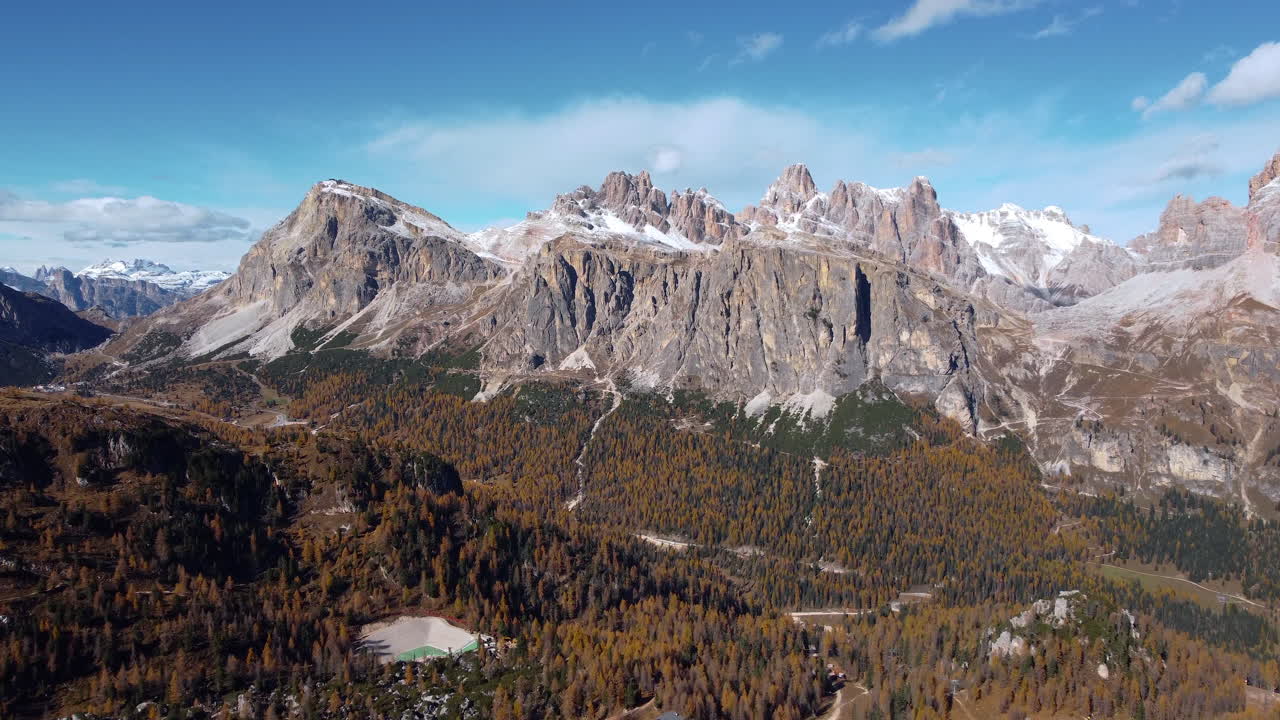 Aerial view of the Dolomites. Lagazuoi. Hike near the Giau Pass, Cinque Torri, Cortina. Mountains in autumn with the first snow on the peaks and yellow larches