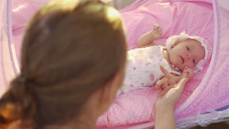 baby holding mothers hand