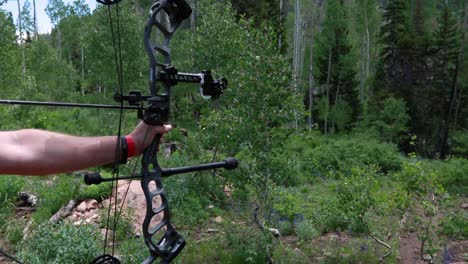 slow motion shot of an archer shooting an arrow in the mountains 2