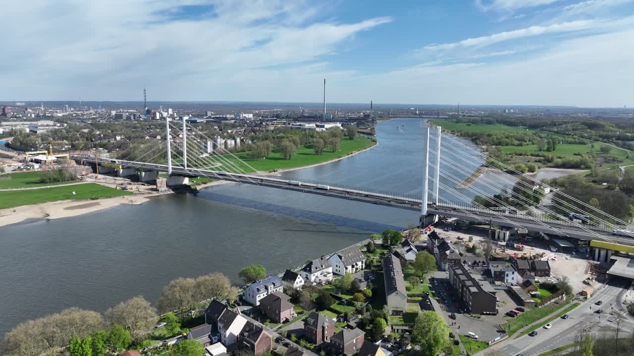rhine river, industrial ruhr region, shipping waterway for industrial transport. Infrastructure, road suspension bridge. Aerial view.