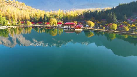 Aerial-Flying-Over-Calm-Reflective-Lower-Kachura-Lake,-also-known-as-Shangrila-Lake-Near-Skardu-In-Gilgit−Baltistan-With-Resorts