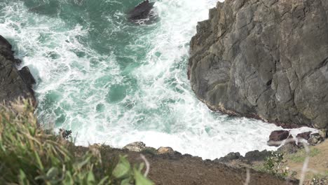 agitated ocean spume foam near rocky cliff byron bay australia coastline
