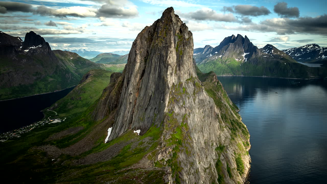 Aerial hyperlapse of dramatic Segla mountain and fjord scenery in Norway, with moving clouds and shifting light. Ideal for travel, adventure, nature and cinematic landscape themes
