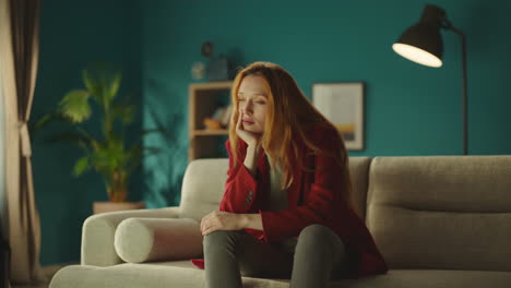 young woman deep thinking on sofa