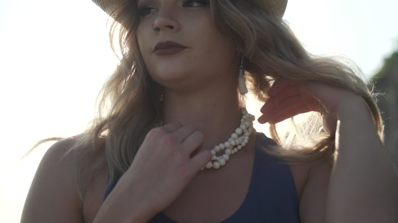 Young Lady Adjusting Necklace While Sunlight Touching Her Face During Summer In Ontario, Canada - Close Up Shot