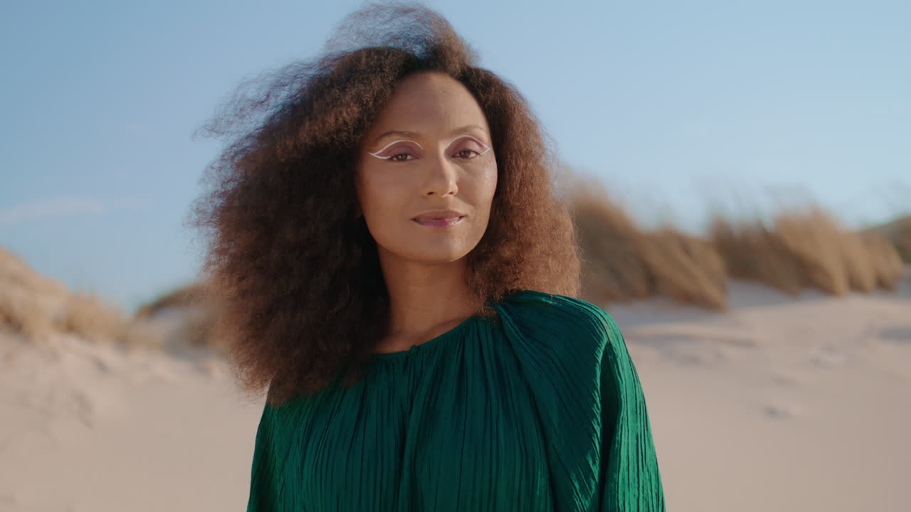 Portrait girl smiling desert summer day. Woman looking camera standing at dunes.