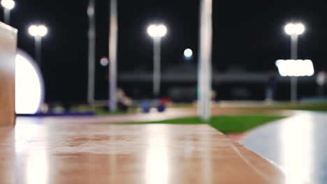 close up of woman's legs doing squat jumps on stairs in the park at night