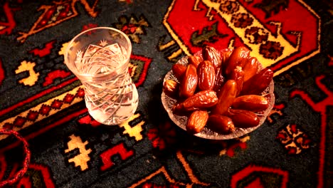 water and dates. iftar is the evening meal. slider view of decoration ramadan kareem holiday. festive greeting card, invitation for muslim holy month ramadan kareem. dark background. selective focus