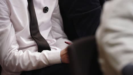 person in formal attire at a meeting