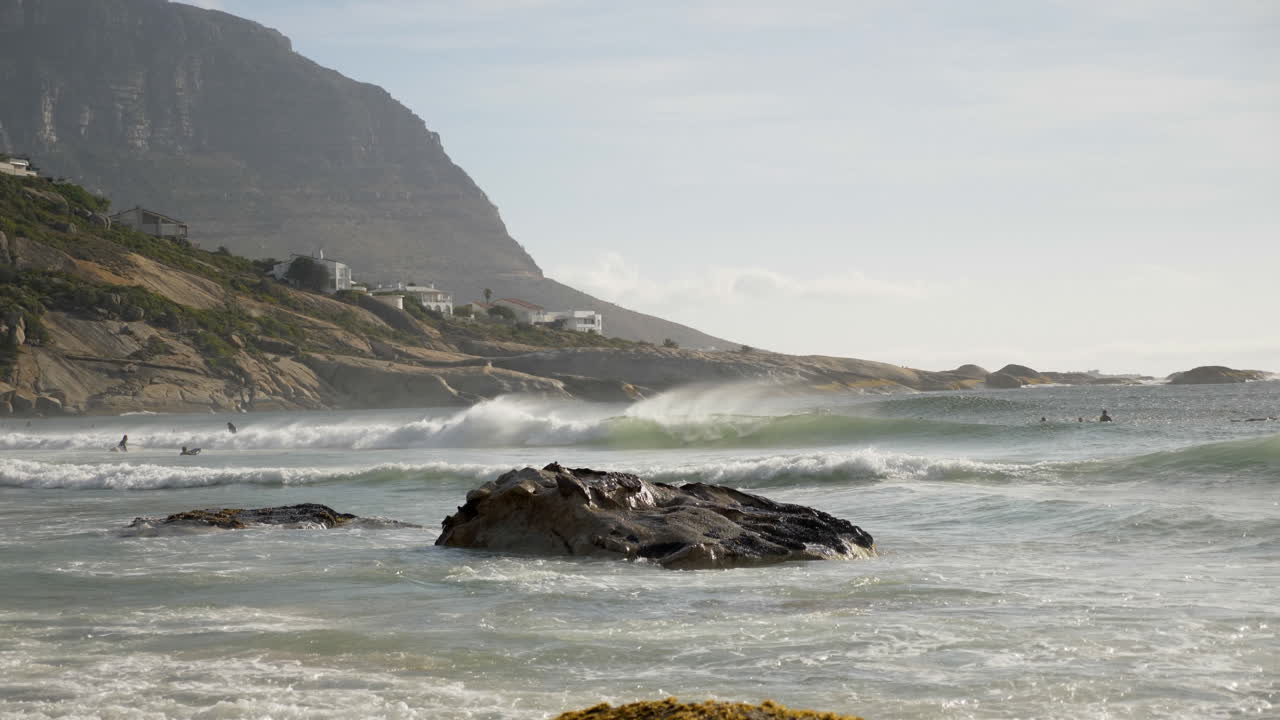 Surfers riding waves in Cape Town South Africa at sunrise