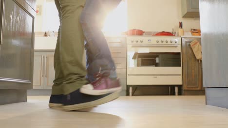 father and daughter dancing in kitchen 4k