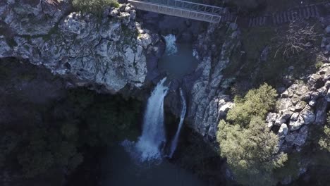 aerial view of a waterfall cascading down a rocky cliff face