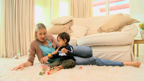 toddler on carpet bored with building blocks