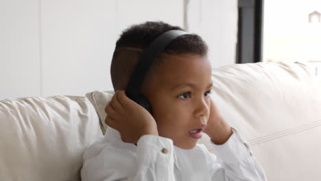 young boy listening to music on headphones