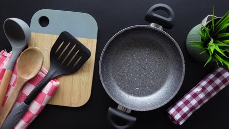 kitchen essentials: pan, spatula, cutting board, and utensils