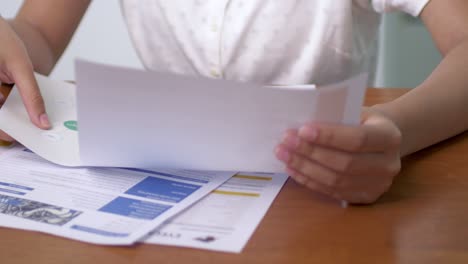 a focused individual organizes and reviews important documents at a desk