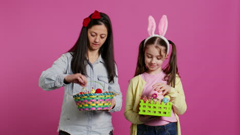 joyful confident child and mother showing easter baskets on camera