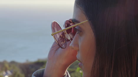 close up portrait beautiful woman wearing sunglasses enjoying view relaxing on summer vacation looking at sunny outdoors contemplating journey