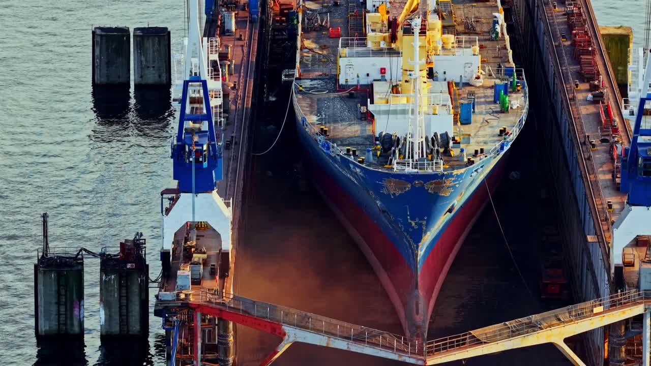 Aerial high angle of shipyard with large vessels under construction, industrial backdrop texture