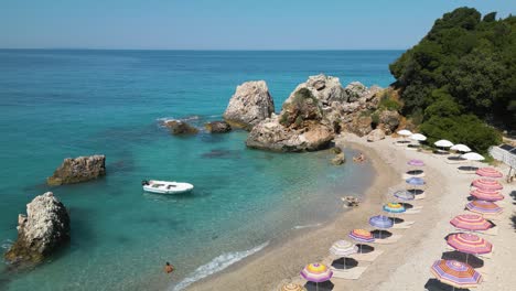 Small-boat-rocks-gently-from-waves-crashing-on-sandy-shores-of-tropical-beach