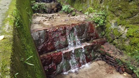 Mossy-stone-zen-cascade,-ancient-decorative-waterfall-in-Daimonji-mountain-Japan