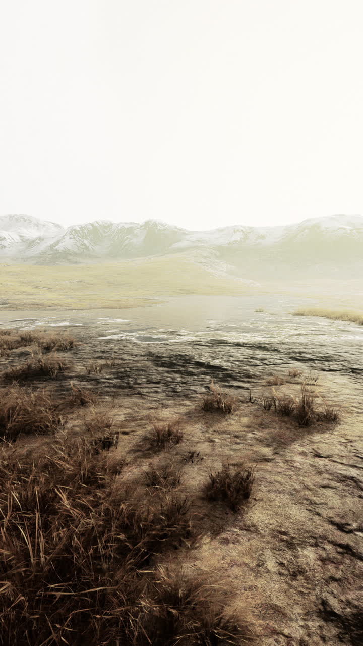 A Foggy Mountain Landscape with Snow-Capped Peaks