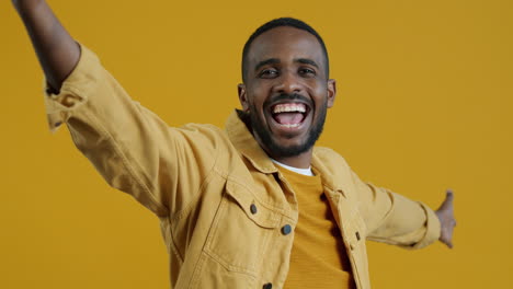 man posing in a yellow jacket