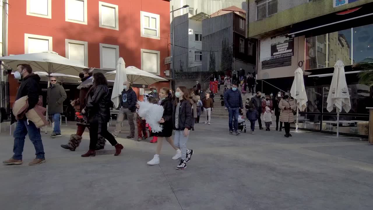 Large Group Of Locals Coming Down Stairs Onto Street In Ordes In Spain